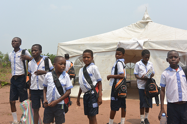 students_arriving_at_school_with_their_supplies.jpg